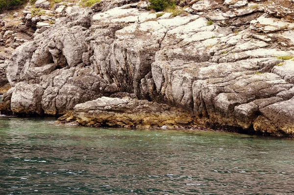 Stone arch and rocks in the sea