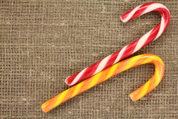 Candy Cane on a gray background of natural fabric