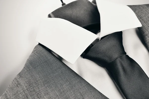 Black and white mens suit, collar and tie closeup.