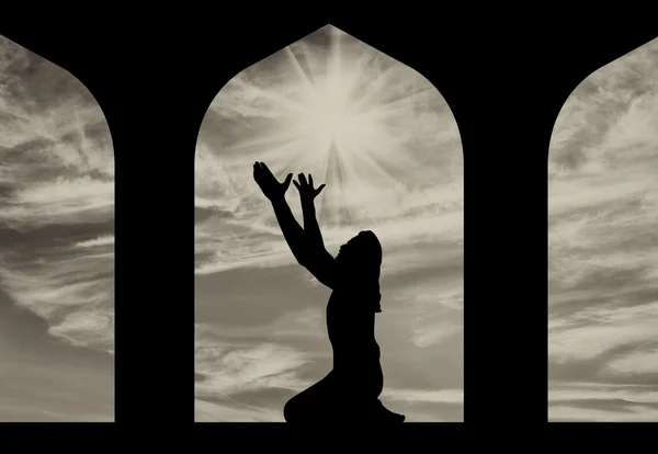 Silhouette of man praying at the Town Hall