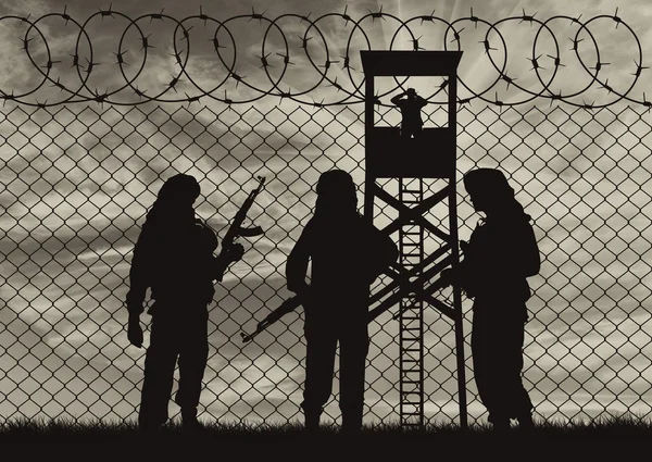 Silhouette terrorists near the border fence