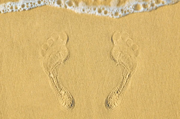 Human footprints on the sand at the beach