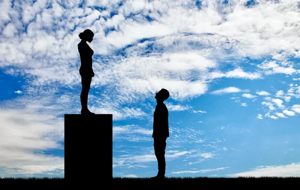 Feminists silhouettes standing on a pedestal looking down at the man