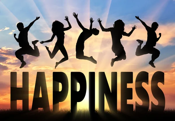 Silhouette people jumping over the word happiness