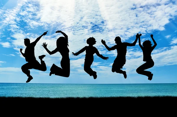 Silhouette of a happy group of people jumping