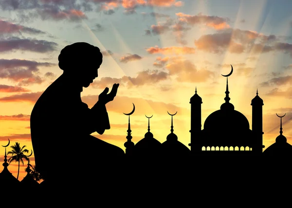 Silhouette of man praying