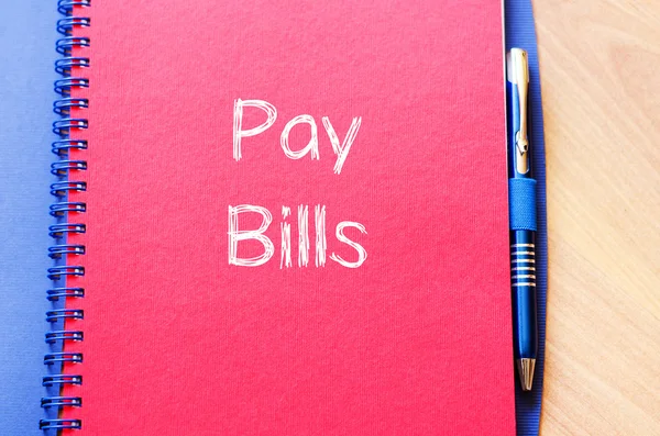 Pay bills write on notebook