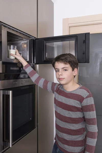 Child preparing a glass of milk