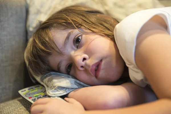 Little girl with TV remote control