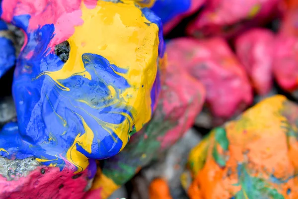 Rocks covered with colorful paint close-up
