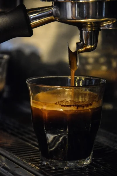 Coffee maker and glass of coffee