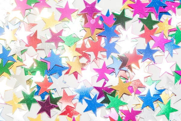 Many toy stars on white background