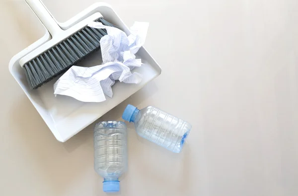 A close up shot of household floor cleaning items and paper