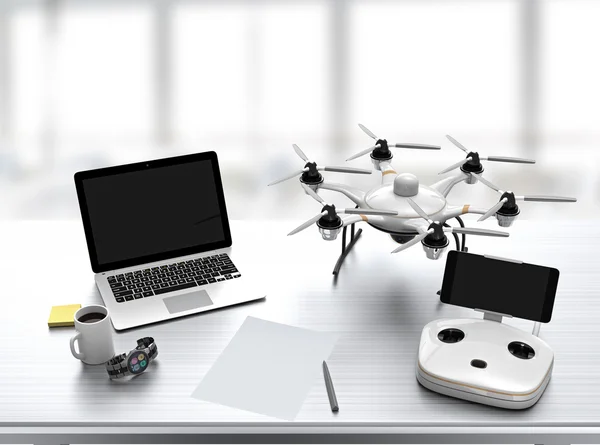 Hexacopter, remote controller, laptop on a desk