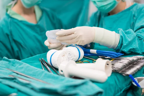 Scrub nurse prepare medical instruments for open heart surgery