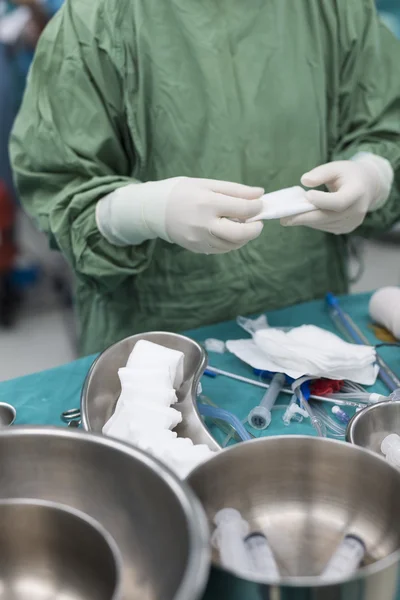 Scrub nurse prepare medical instruments for open heart surgery