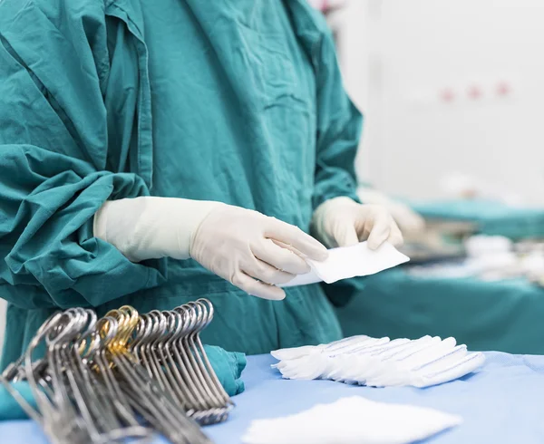 Scrub nurse prepare medical instruments