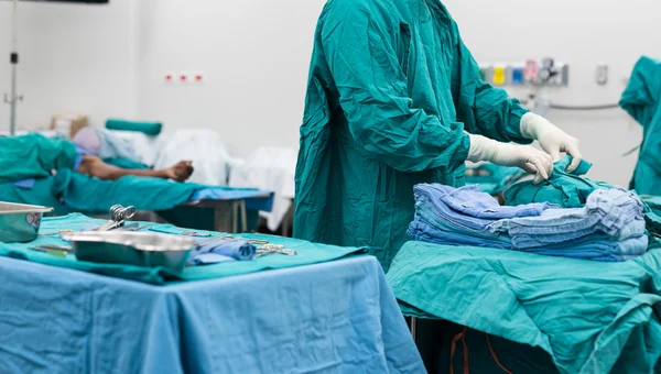 Scrub nurse prepare medical equipments for surgery