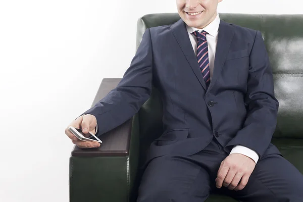 Smiling businessman with phone in hand on the white background