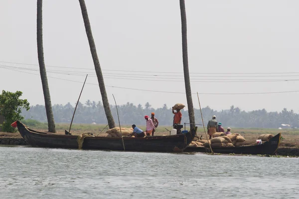 ALLEPPEY, KERALA, INDIA, MARCH 31, 2015: Some men transport, overload, put on them head bags of rice