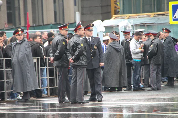 The Russian police during a rain, near procession of communists