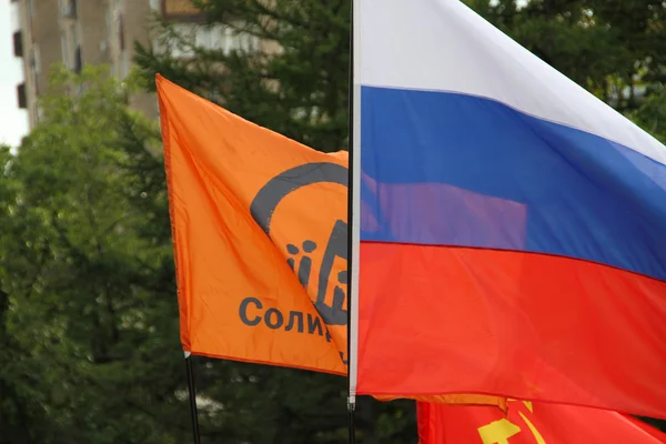 Flags on oppositional meeting - Russian, the movements Solidarity, communistic