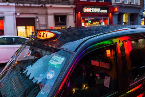 London taxi in motion blur at night