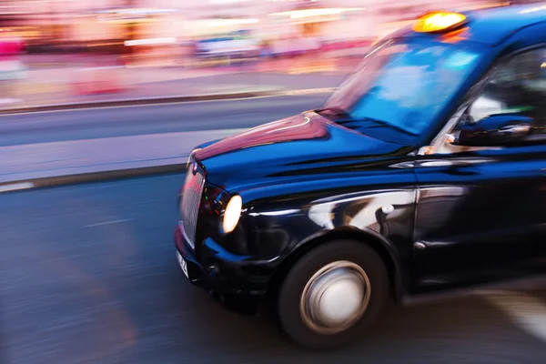 London taxi in motion blur at night