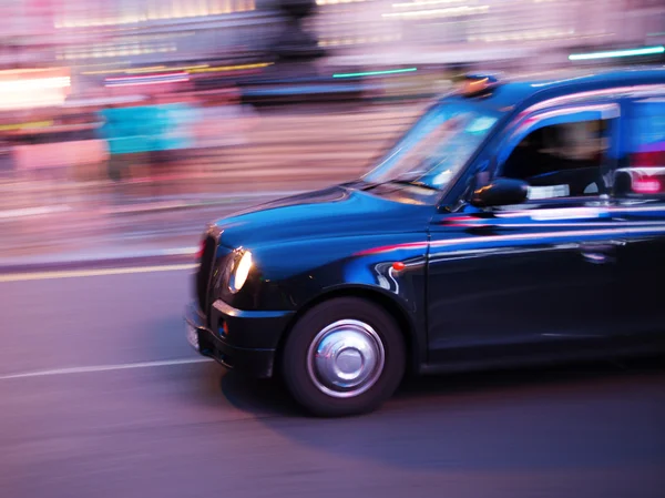 London taxi in motion blur at night