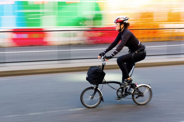 Cyclist in motion blur in the city traffic of London, UK