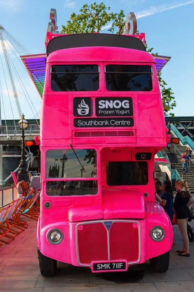 Pink double decker bus in London, UK