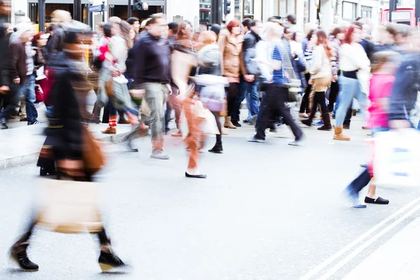People in motion blur crossing a street in London City