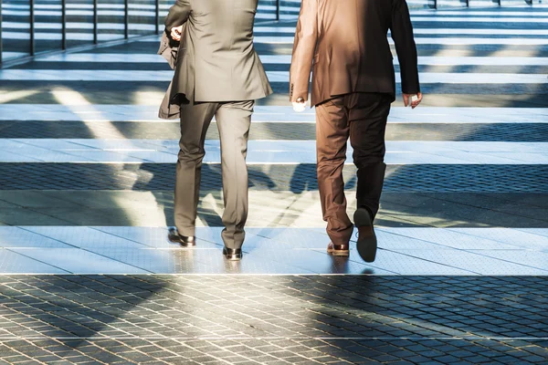 Two business people walking in an office area
