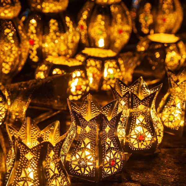 Rows of arabic lanterns with burning candles