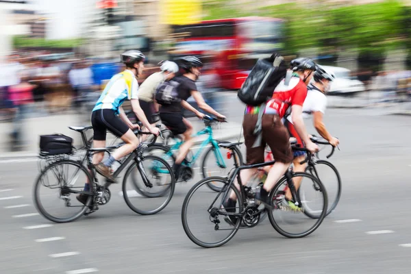 Group of cyclists in motion blur in the city traffic