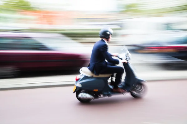 Scooter rider in motion blur