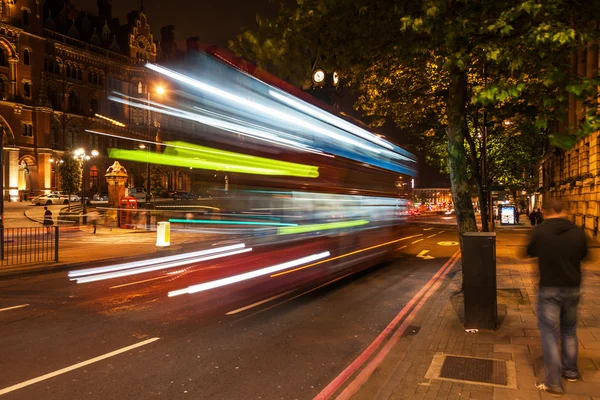 London bus in motion blur at night in London, UK