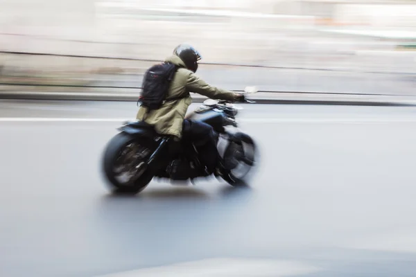 Motorcycle rider in motion blur