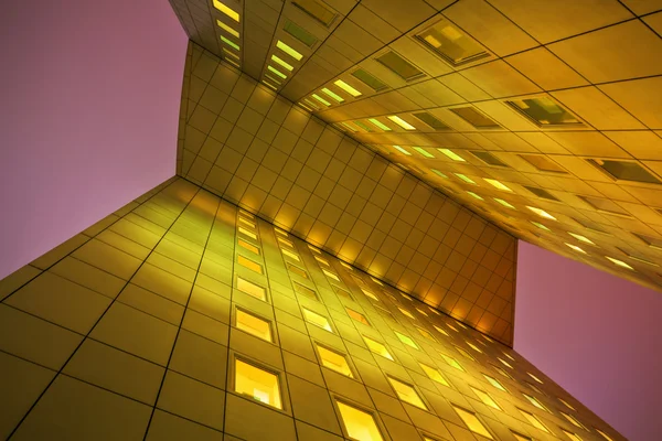 Low angle view of a modern office tower at night in La Defense, Paris, France