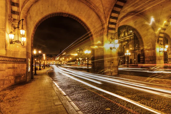Light trails of traffic in an underpass to the Louvre in Paris, France, at night