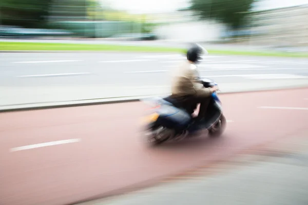 Scooterist in motion blur