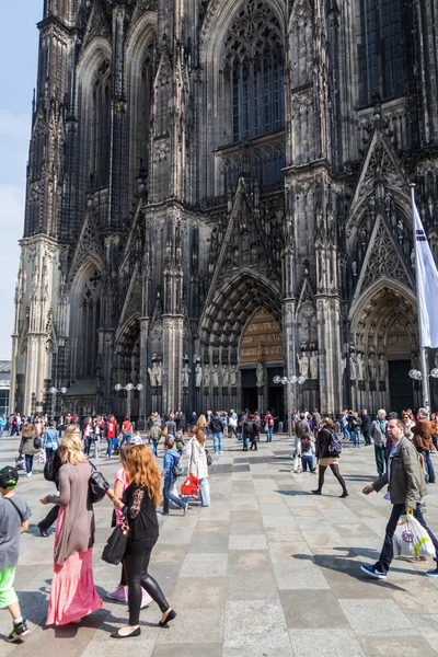 Crowd of people on the move in front of the famous Cologne Cathedral in Cologne, Germany