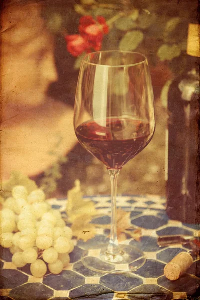 Vintage style picture of a still life with red wine