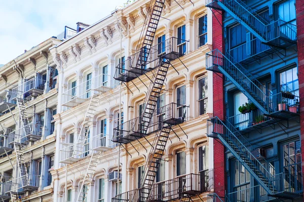 Old buildings with fire escape stairs in Soho, NYC
