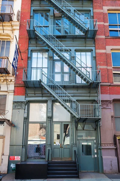 Old buildings with fire escape stairs in Soho, NYC