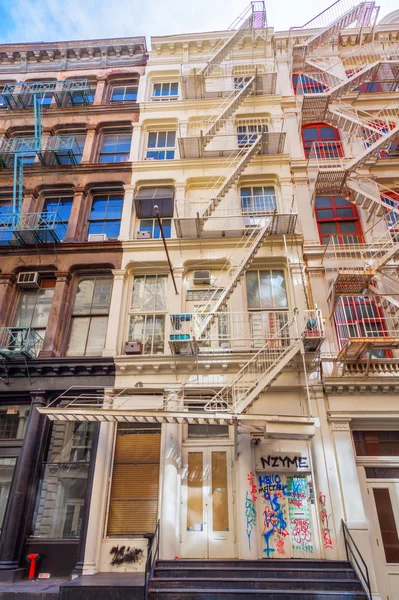 Old residential buildings with fire escape stairs in Soho, New York City