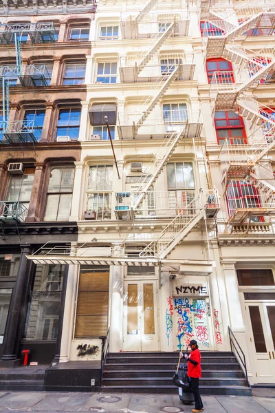 Old residential buildings with fire escape stairs in Soho, New York City