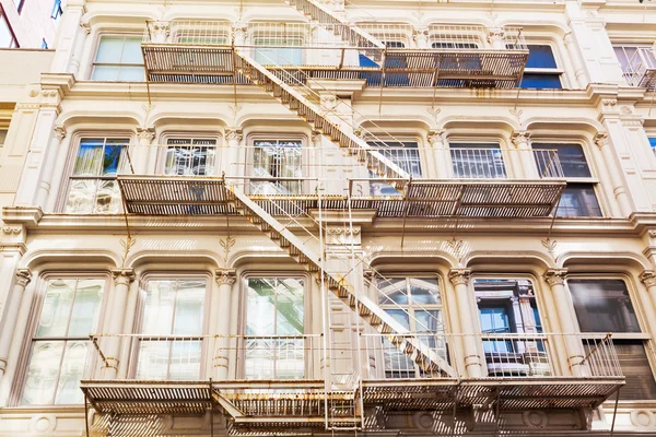Old residential buildings with fire escape stairs in Soho, New York City