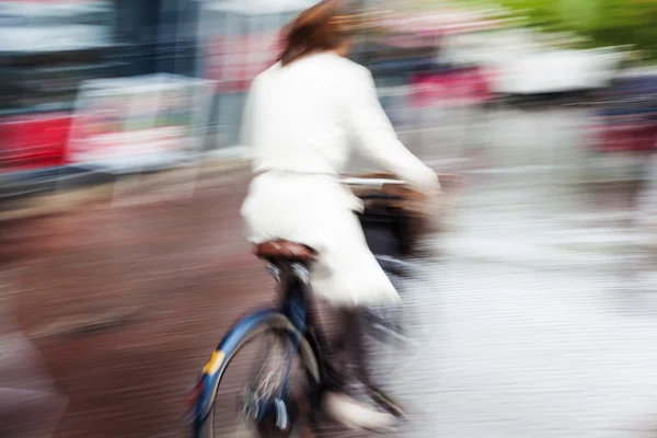 Bicycle rider in the rainy city