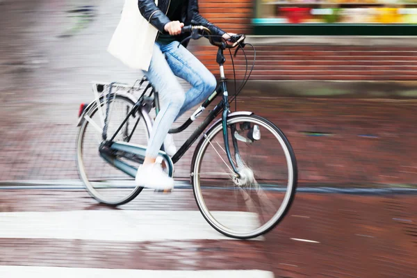 Bicycle rider in the rainy city